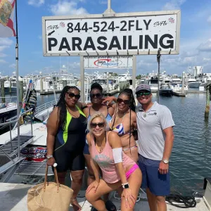 a group of people holding a sign posing for the camera