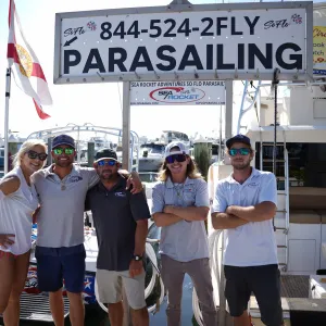 a group of people standing next to a man holding a sign