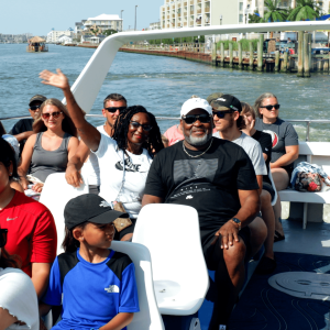 a group of people standing next to a body of water