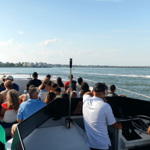 a group of people standing next to a body of water