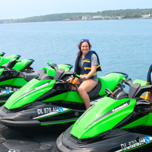two girls on green jet skis