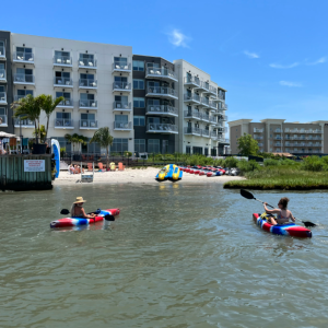 a group of people in a small boat in a body of water