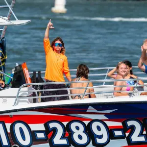 a group of people riding on the back of a boat