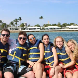 a group of people on a boat posing for the camera