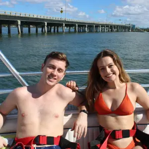 a couple of people that are standing in front of a body of water