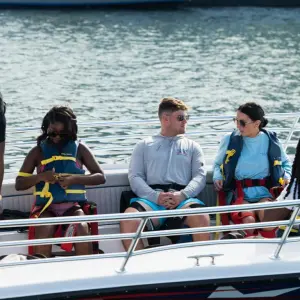 a group of people on a boat in the water