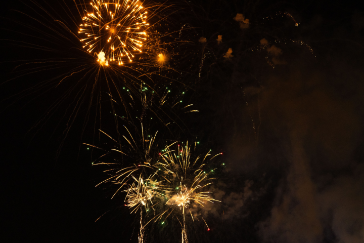 Colorful fireworks bursting against a dark night sky.